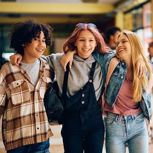 Group of friends smiling and laughing in the corridors